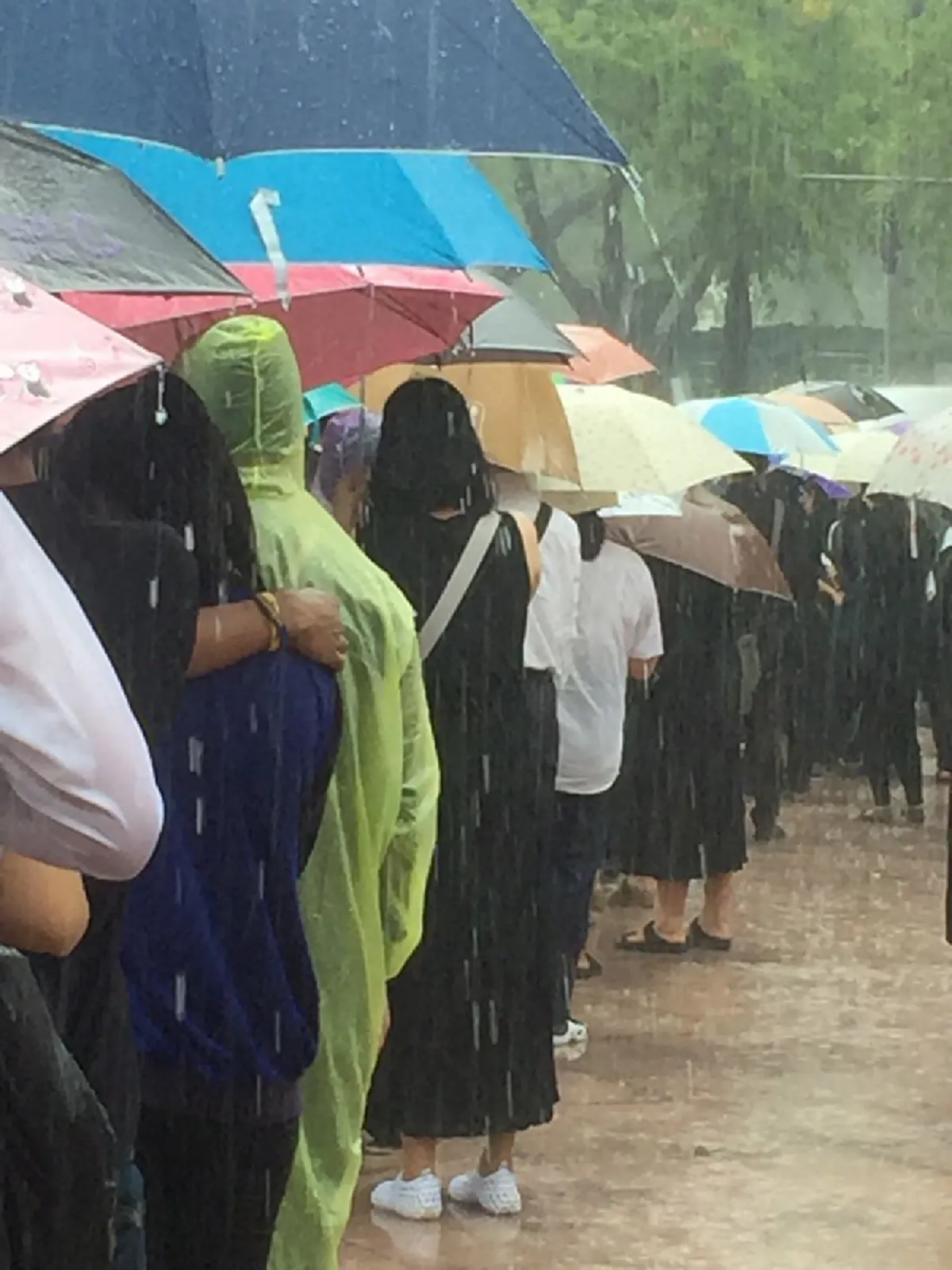สายฝนจะแรงแค่ไหน ใจไม่หวั่น...ประชาชนนับพัน เข้าแถวรอลงนามถวายความอาลัยท่ามกลางสายฝนที่กระหน่ำตกอย่างหนัก